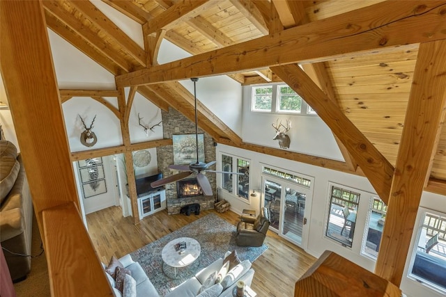 living room with high vaulted ceiling, light hardwood / wood-style floors, wood ceiling, and beamed ceiling