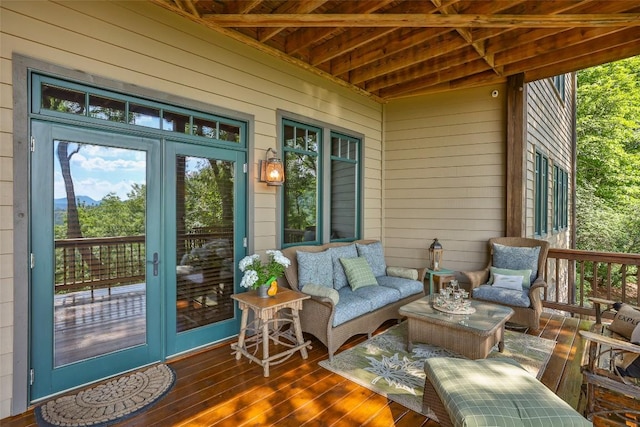 wooden terrace with an outdoor living space and french doors