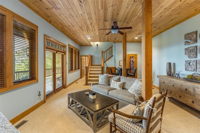 carpeted living room with ceiling fan and wood ceiling