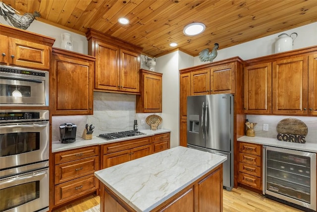 kitchen with wine cooler, appliances with stainless steel finishes, backsplash, wooden ceiling, and a kitchen island