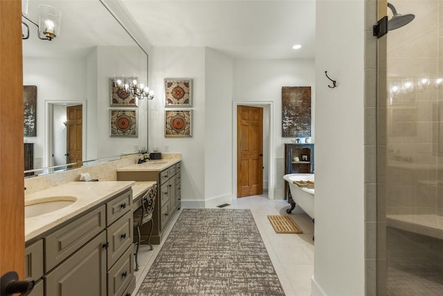 bathroom with a bath, vanity, and tile patterned flooring