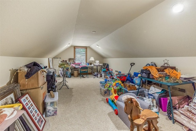 recreation room featuring carpet and lofted ceiling