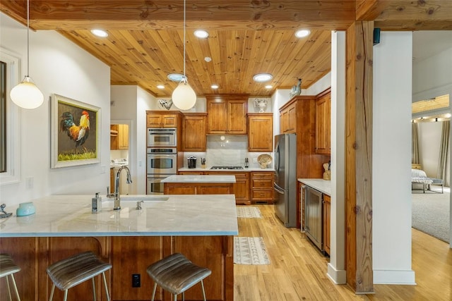 kitchen with wood ceiling, stainless steel appliances, light hardwood / wood-style flooring, and pendant lighting