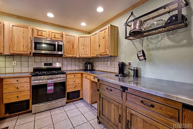 kitchen featuring light brown cabinetry, stainless steel counters, ornamental molding, light tile patterned floors, and stainless steel appliances