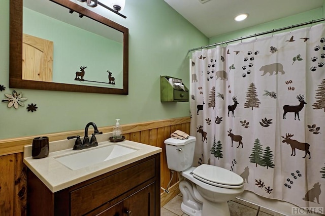 bathroom with toilet, tile patterned floors, wooden walls, and a shower with shower curtain