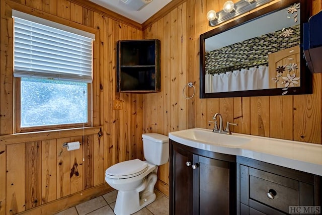 bathroom featuring wood walls, tile patterned flooring, vanity, ornamental molding, and toilet