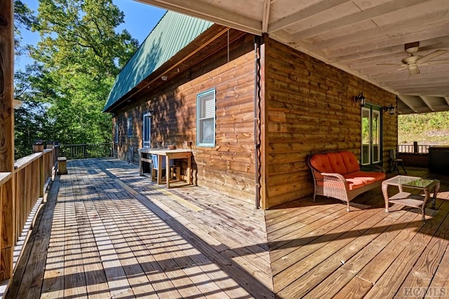 wooden deck with an outdoor hangout area and ceiling fan