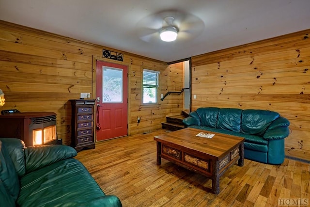 living room featuring wooden walls and light wood-type flooring