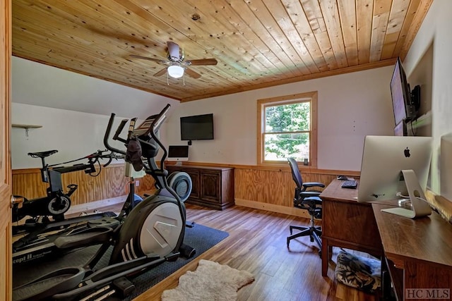 home office with wood walls, ceiling fan, crown molding, wooden ceiling, and light wood-type flooring