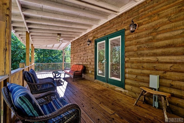 wooden terrace featuring ceiling fan and french doors