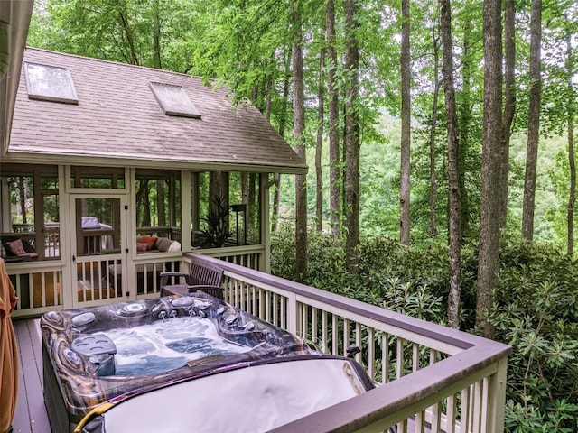 wooden terrace featuring outdoor dining area and a sunroom