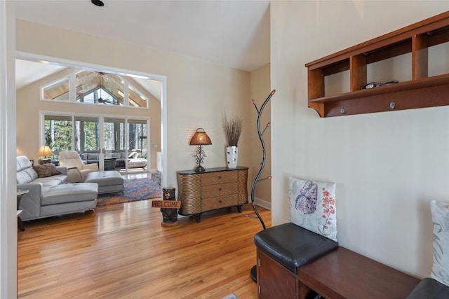 living area featuring lofted ceiling and light wood finished floors