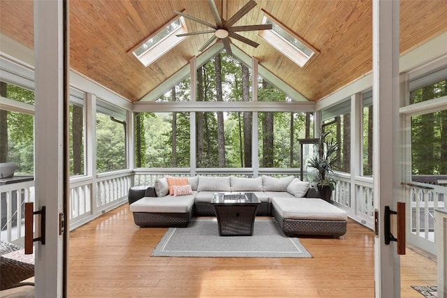 sunroom / solarium featuring vaulted ceiling with skylight and wood ceiling