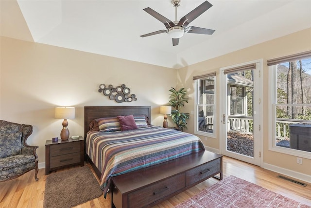 bedroom with baseboards, visible vents, ceiling fan, wood finished floors, and access to exterior