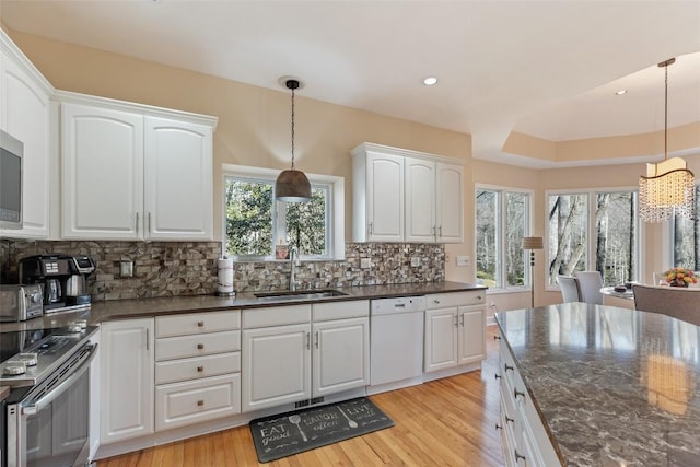 kitchen with a sink, white cabinetry, stainless steel electric range, decorative backsplash, and dishwasher