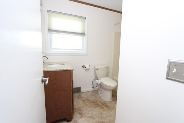 bathroom featuring tile patterned flooring, walk in shower, vanity, baseboards, and toilet