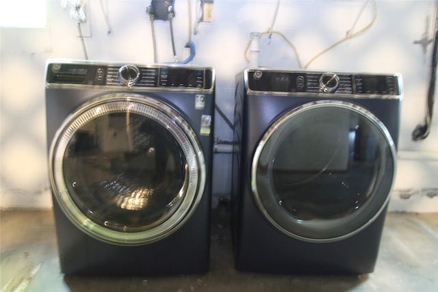 washroom featuring washer and dryer and laundry area