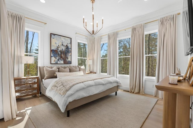 bedroom with light wood-type flooring and multiple windows