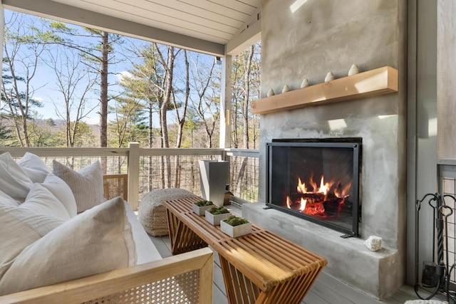 sunroom with a warm lit fireplace