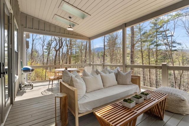 sunroom / solarium featuring wood ceiling and lofted ceiling