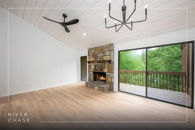 233 Meadow Way Unit 1615, Sapphire, NC 28774 - unfurnished living room featuring lofted ceiling, wood finished floors, baseboards, a stone fireplace, and a chandelier