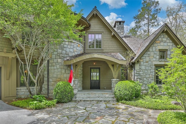 525 High Mountain Dr, Cashiers, NC 28717 - view of exterior entry featuring stone siding and a chimney