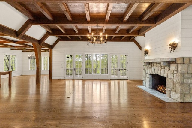 525 High Mountain Dr, Cashiers, NC 28717 - unfurnished living room with wood finished floors, a chandelier, a stone fireplace, wooden walls, and wood ceiling