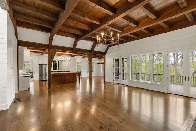 525 High Mountain Dr, Cashiers, NC 28717 - unfurnished living room with a chandelier, french doors, wooden ceiling, dark wood-style flooring, and plenty of natural light