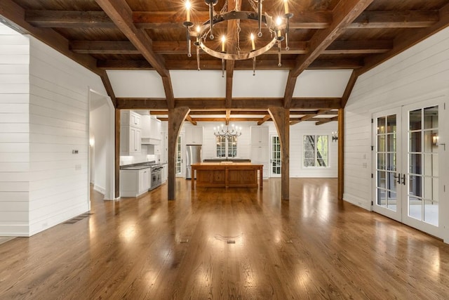 525 High Mountain Dr, Cashiers, NC 28717 - unfurnished living room with a chandelier, wood walls, french doors, wood ceiling, and wood finished floors