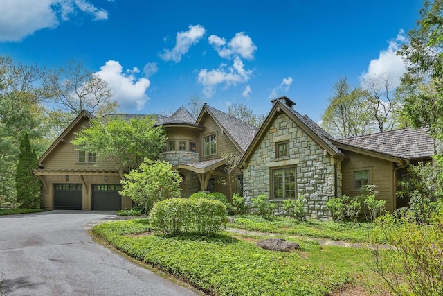 525 High Mountain Dr, Cashiers, NC 28717 - view of front of property featuring stone siding, a garage, driveway, and a chimney