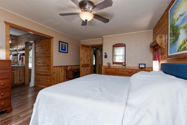 3050 N Hwy 107, Cashiers, NC 28736 - bedroom with wooden walls, a textured ceiling, dark wood-style floors, crown molding, and wainscoting