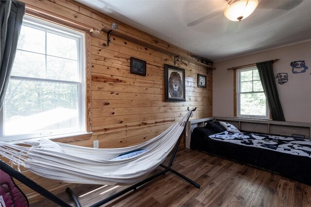 3050 N Hwy 107, Cashiers, NC 28736 - bedroom featuring wooden walls, wood finished floors, and a ceiling fan