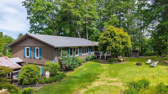 3050 N Hwy 107, Cashiers, NC 28736 - back of property featuring a storage shed, a lawn, a fire pit, and a wooden deck