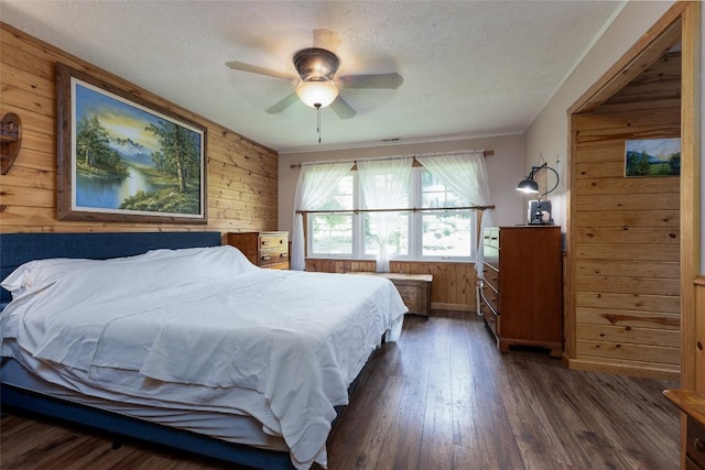 3050 N Hwy 107, Cashiers, NC 28736 - bedroom with wooden walls, dark wood-style floors, a textured ceiling, and ceiling fan