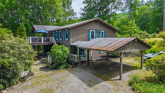3050 N Hwy 107, Cashiers, NC 28736 - back of house featuring a metal roof, a wooden deck, a carport, and dirt driveway