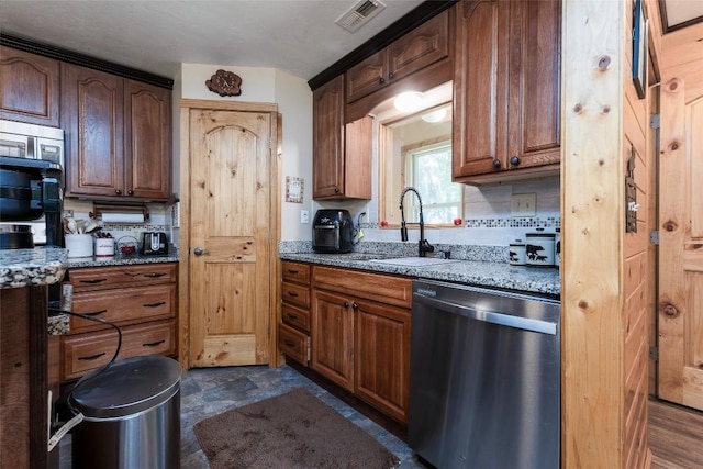 3050 N Hwy 107, Cashiers, NC 28736 - kitchen featuring dishwasher, light stone counters, tasteful backsplash, and dark stone finish flooring