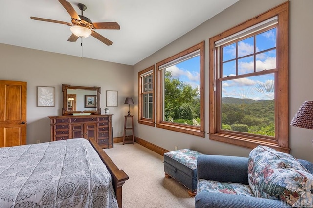 bedroom with light carpet and ceiling fan