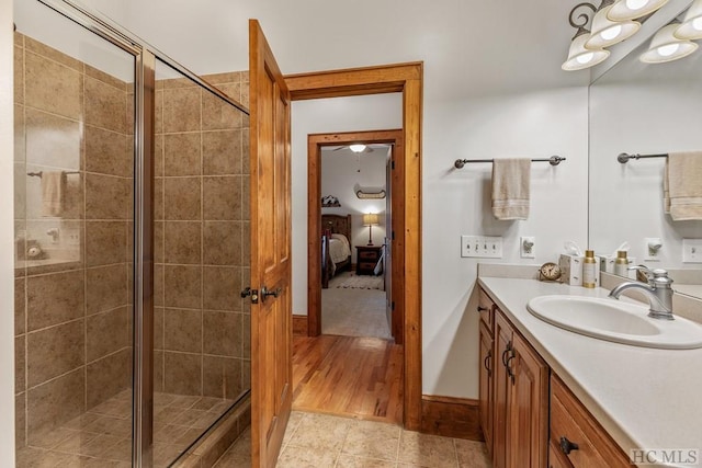 bathroom featuring vanity and a shower with shower door