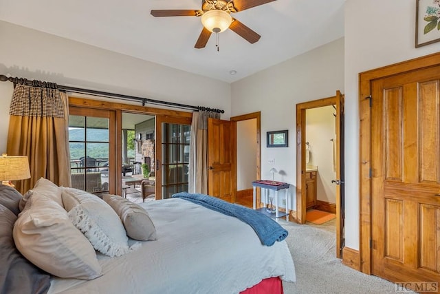 bedroom with ceiling fan, light colored carpet, ensuite bathroom, and access to outside