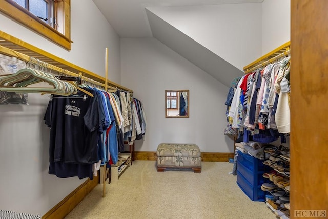 spacious closet with vaulted ceiling and carpet floors