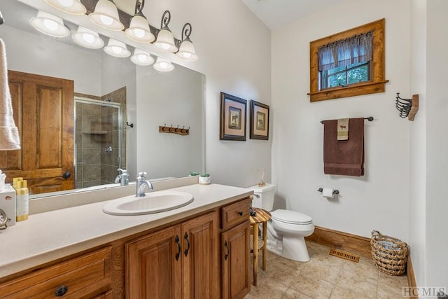 bathroom featuring vanity, toilet, and walk in shower