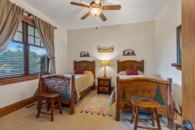 bedroom with ceiling fan and light carpet