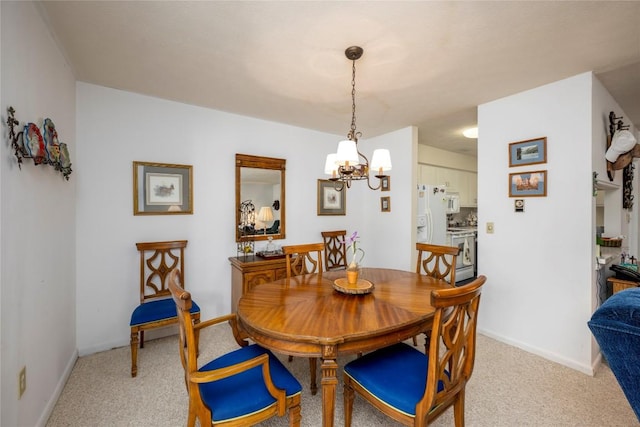 dining room featuring an inviting chandelier, baseboards, and light carpet