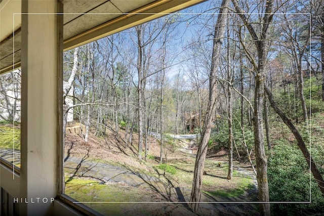 view of yard featuring a forest view