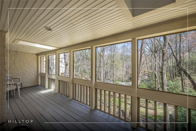 unfurnished sunroom with wooden ceiling and hardwood / wood-style flooring