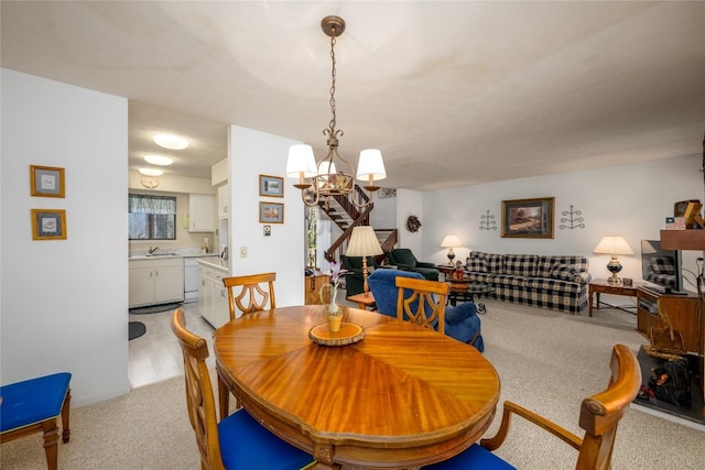 dining room featuring a chandelier, stairway, and light carpet