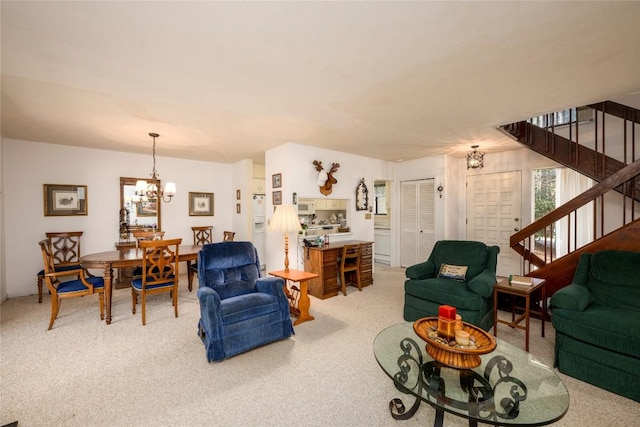 living room with an inviting chandelier, stairway, and carpet