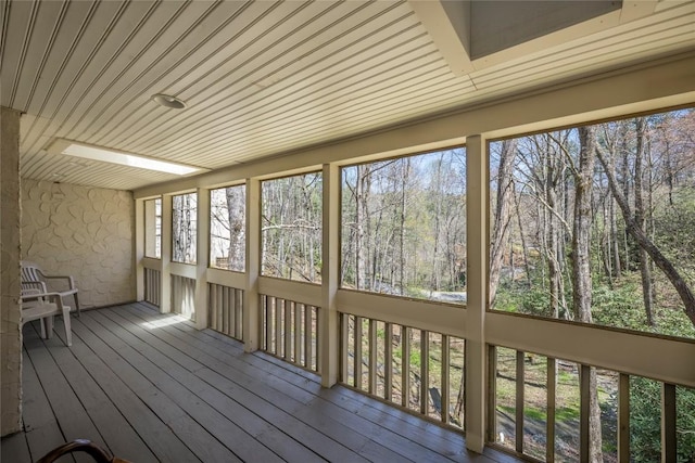 unfurnished sunroom with hardwood / wood-style floors and wood ceiling