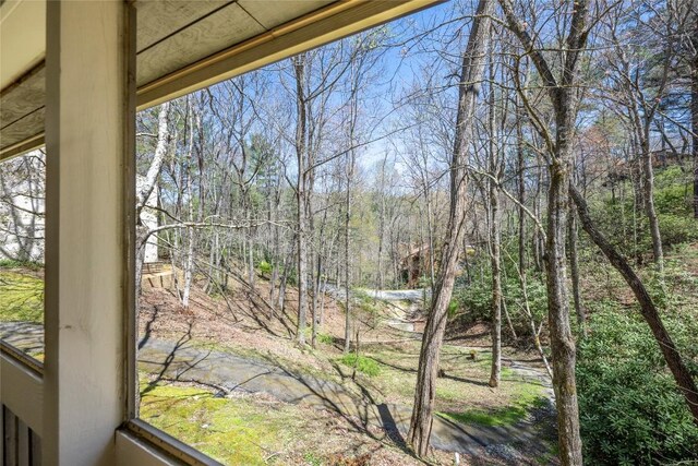 view of yard featuring a forest view