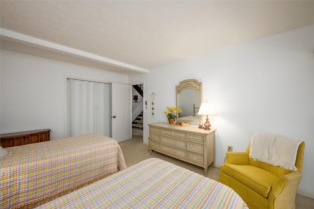 bedroom with a closet and light colored carpet